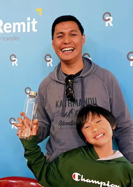 father and son holding an OrbitRemit drink bottle together